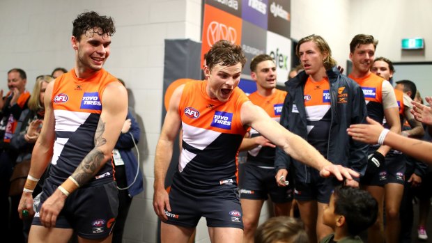 Heath Shaw of the Giants and teammates greet fans in their change room after winning the round 19 AFL match between the Greater Western Sydney Giants and the Fremantle Dockers at Spotless Stadium in Sydney, Australia.