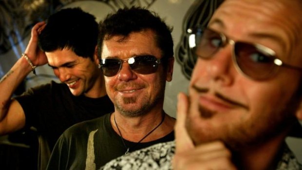 A younger Tim Farriss (centre) with Kirk Pengilly (right) and canadian lead singer JD Fortune.