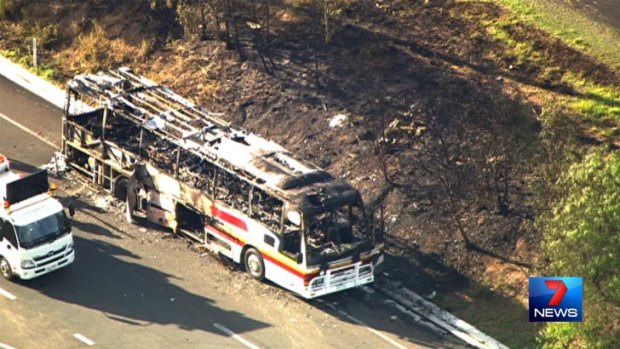 The bus fire also sparked a small grass fire on the side of the Warrego Highway. Photo: Seven News.