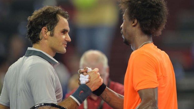 Gael Monfils of France (right) shakes hands with Roger Federer of Switzerland after the match.