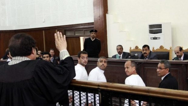Trial adjourned: Peter Greste with his colleagues appear before an Egyptian court.