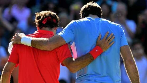 Drained ... Roger Federer (left) and Juan Martin del Potro after their epic match.