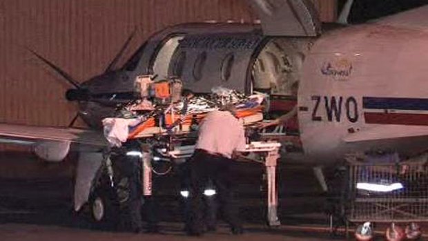 An injured firefighter arrives in Perth to be taken to hospital. <i>Photo: Channel Ten</i>