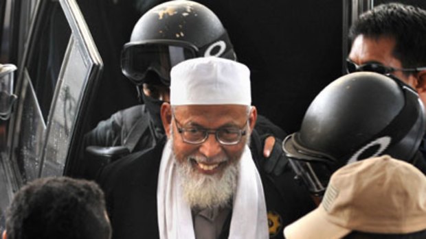 Arrested ... the radical Islamist cleric Abu Bakar Bashir is brought into police headquarters in Jakarta after his arrest yesterday. Police claim he is the head of a  terrorist group planning attacks.