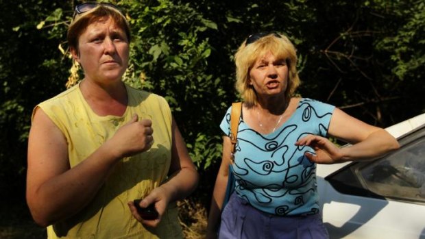 Teachers Olga Korostilenko (left) and Marina Tiheeva fleeing the shelling in Shakhtersk on Thursday.