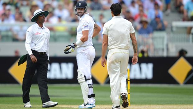 Umpire Kumar Dharmasena intervenes in a verbal spat between Mitchell Johnson and Kevin Pietersen.