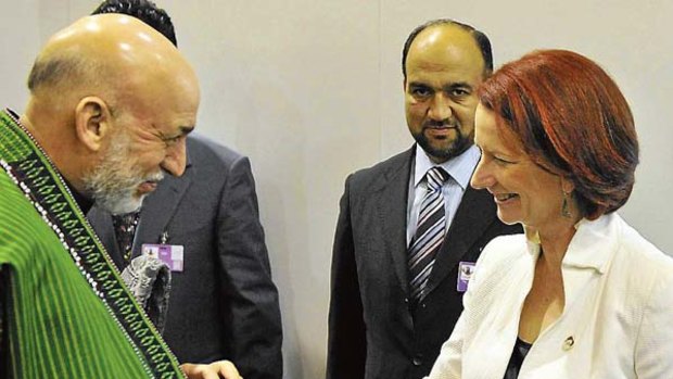"On the same page" ... Prime Minister Julia Gillard meets Afghan President Hamid Karzai in Lisbon.