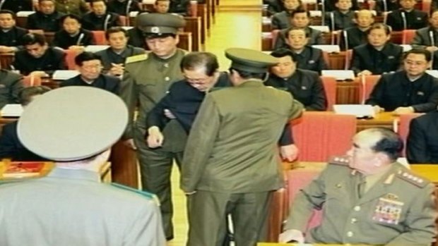 North Korean television released images that it said showed Jang Song-thaek being dragged from his chair by two police officials during a meeting in Pyongyang, North Korea.