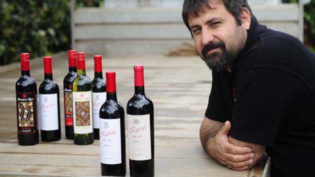 Emanuel Skorpos with a selection of Flinders Run wines alongside a counterfeit Chinese copy, on the right.