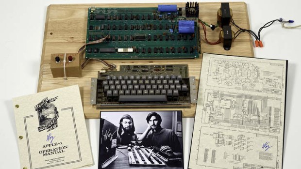 An Apple 1 prototype computer, built in 1976, accompanied by an operation manual and schematic as well as a photo of its inventors, Steve Wozniak, left, and Steve Jobs.