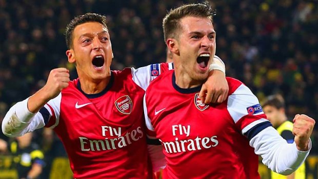 Top form: Arsenal's Aaron Ramsey, right, celebrates with Mesut Ozil after scoring against Borussia Dortmund midweek in the UEFA Champions League.