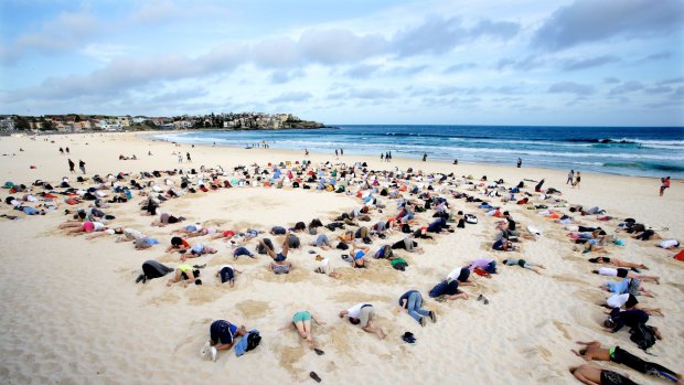 Bondi climate change protesters bury their heads in the sand ahead of the weekend's G20 meeting.