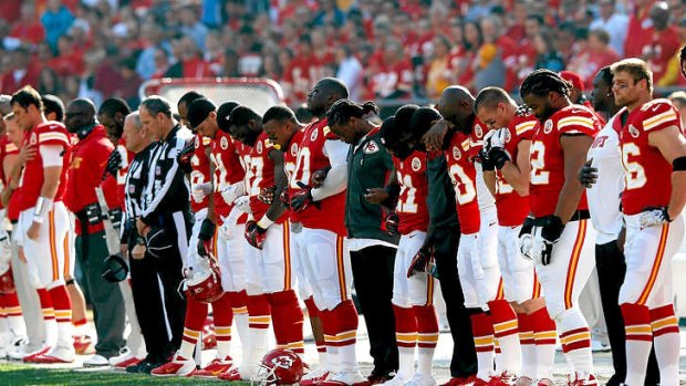 The Kansas City Chiefs pause for a moment of silence honoring domestic abuse.