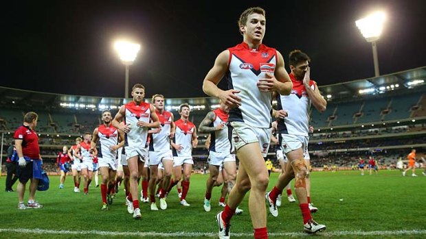 On the run: Melbourne's Jack Trengove leads the team off the ground.