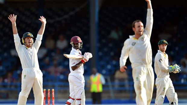 Australia's Ricky Ponting, left, Nathan Lyon, second right, and Matthew Wade, right, make a conventional appeal for the wicket of West Indies batsman Kemar Roach.