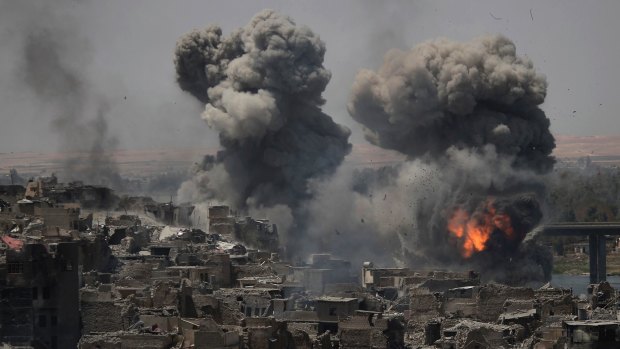 Airstrikes target Islamic State positions on the edge of the Old City a day after Iraq's prime minister declared "total victory" in Mosul, Iraq.