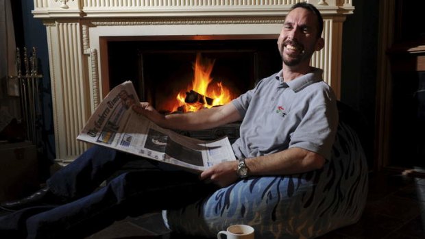 Dominic Stinziani, 44 of Higgins, in front of his open fireplace.