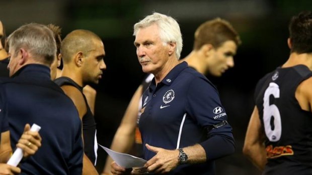 Mick Malthouse with his team at quarter-time.