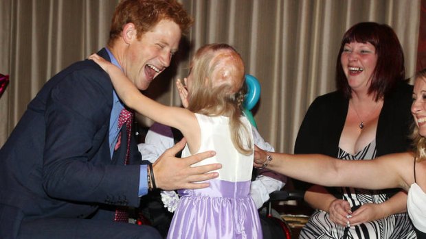 Prince Harry meets Hope Hillis as he attends the WellChild Awards in London.