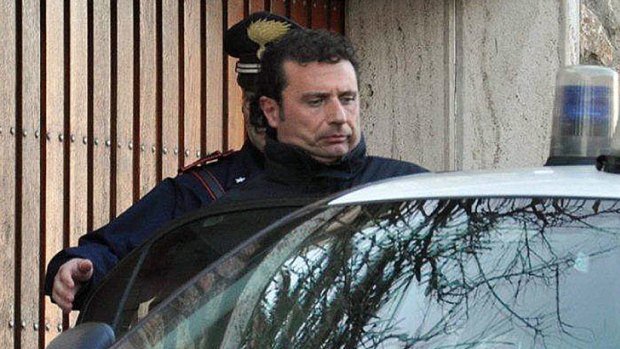 "Abandoned ship" ... Costa Concordia  captain Francesco Schettino is escorted away by police after his arrest.