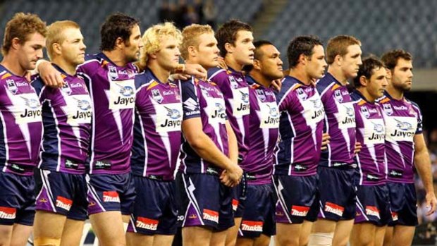 Storm players observe a minute's silence before unleashing their  power on the hapless Warriors. The huge crowd backed them all the way.