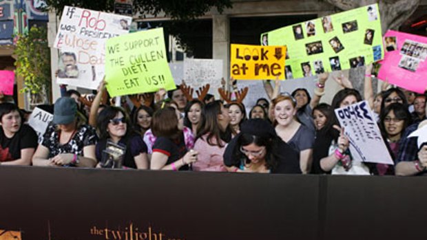 Fans who have camped out on sidewalks for several days stand along the red carpet waiting for the start of the premiere of The Twilight Saga New Moon in Los Angeles.