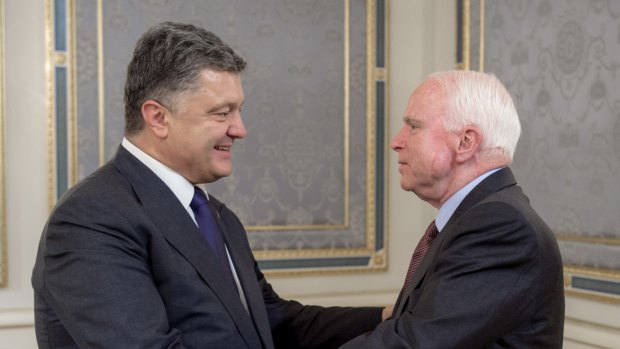 Ukrainian President Petro Poroshenko and US Senator John McCain, right, in Ukraine on Saturday. 