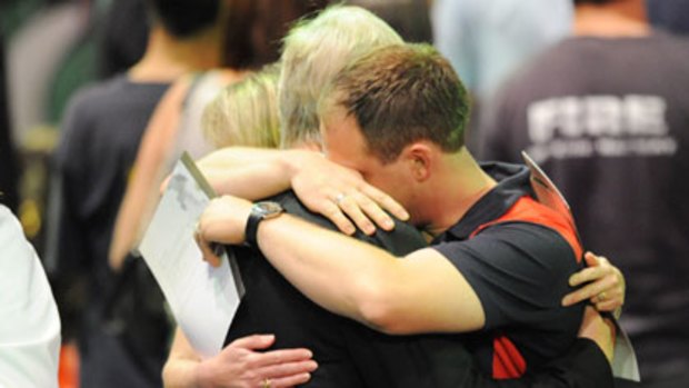 Mourners comfort each other at Rod Laver Arena.