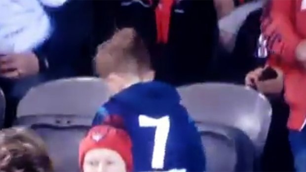Disappointed, the young fan with the Fyfe #7 guernsey returns to his seat.