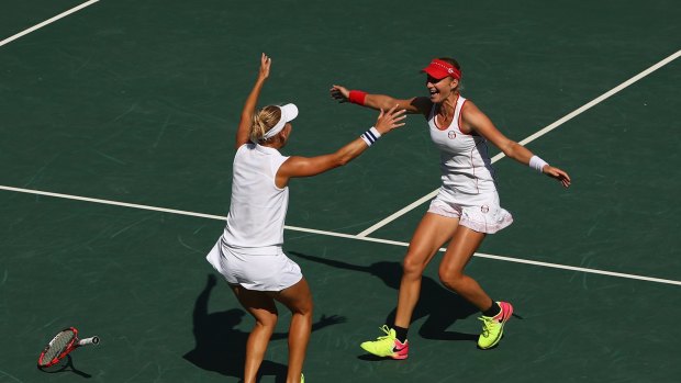 Elena Vesnina and Ekaterina Makarova of Russia celebrate victory in the women's doubles gold medal match.