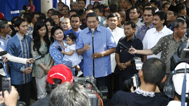 Presidential candidate Susilo Bambang Yudhoyono (centre), accompanied by his family, speaks to journalists after his vote in Cikeas.