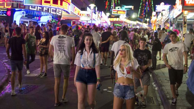 Young British tourists walk down Punta Ballena street as they have fun in the Magalluf zone, in Calvia on Mallorca Island.