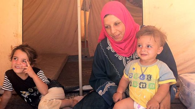 ''They were shooting directly at the children'' &#8230; Nasim Abu Ziad and two of her four children at the camp in Jordan.