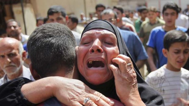 Six bombs ... an Iraqi woman cries after one of the blasts.