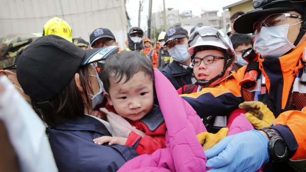 A baby boy is rescued from a collapsed building after an earthquake in Tainan, Taiwan.