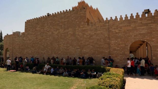 Iraqi Christians who fled the violence in the village of Qaraqush, about 30 kilometres east of the northern province of Nineveh, rest upon their arrival at the Saint-Joseph church in the Kurdish city of Arbil.