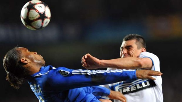 Clash of the high flyers . . . Didier Drogba of Chelsea fights for the ball with Walter Andrian Samuel of Inter Milan.