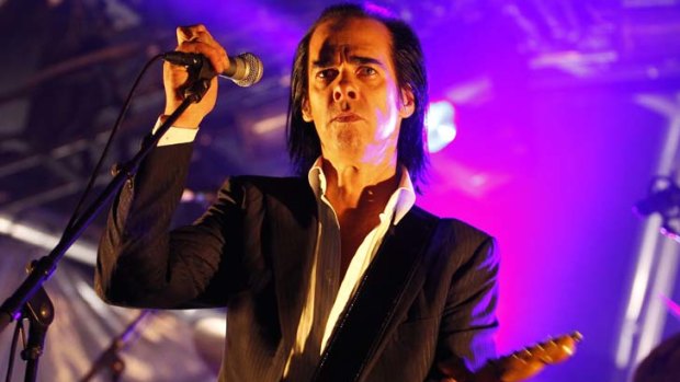 Nick Cave performs on stage.