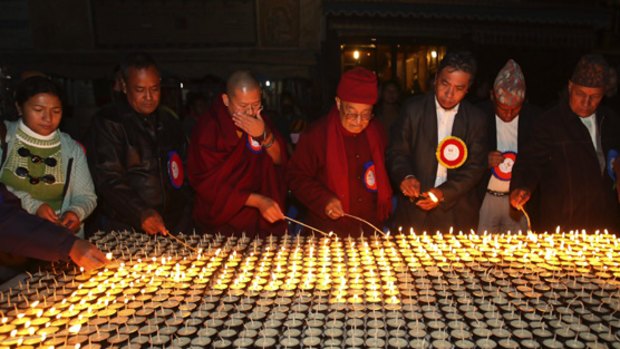 Representatives of various faiths light butter lamps in Kathmandu at a protest against the ritual slaughter of thousands of animals.