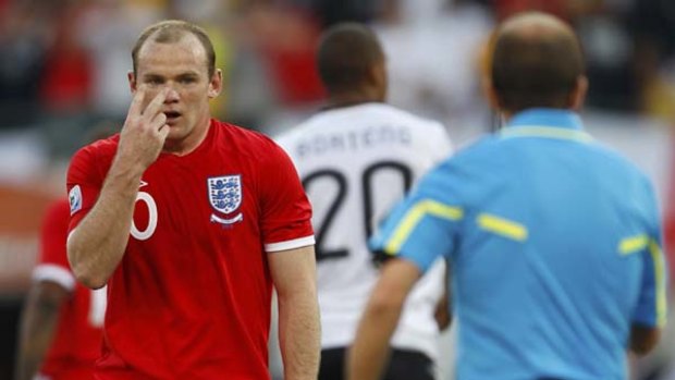 Embarrassing rout ... Wayne Rooney gestures to the referee's assistant after Frank Lampard's goal was disallowed.