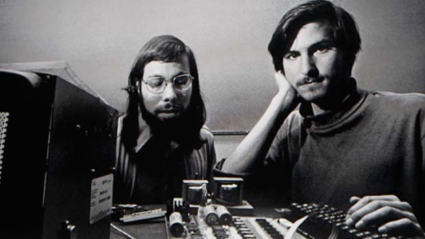 Steve Jobs stands beneath a photograph of him and Apple-co founder Steve Wozniak from the early days of Apple during the launch of the new "iPad" tablet in January 2010.