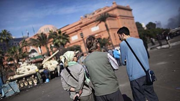 Foreign tourists stand outside the Egyptian Museum in Cairo's central Tahrir Square. Some tourists are pressing ahead with their Egyptian holidays despite the unrest.