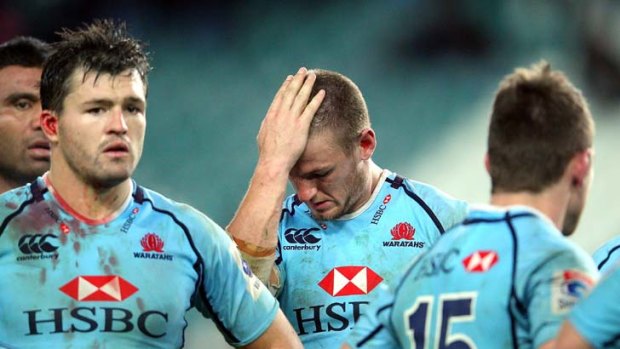 Feeling blue ... dejected Waratahs contemplated Saturday's defeat, their sixth in a row, to the Hurricanes at Allianz Stadium.