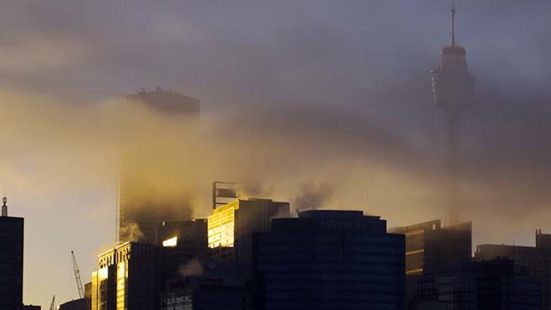 Clouding the issue: The city centre at sunrise on Wednesday morning.
