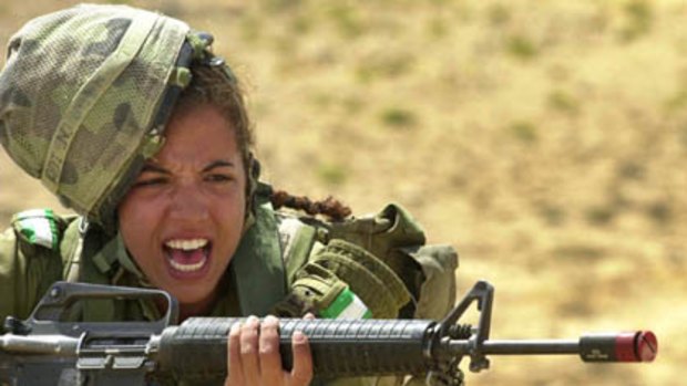 In a picture released by Israeli Defence Forces press office, an Israeli army female soldier shouts during a week-long survival course for women in the infantry at an undisclosed location in Israel May 23, 2005.