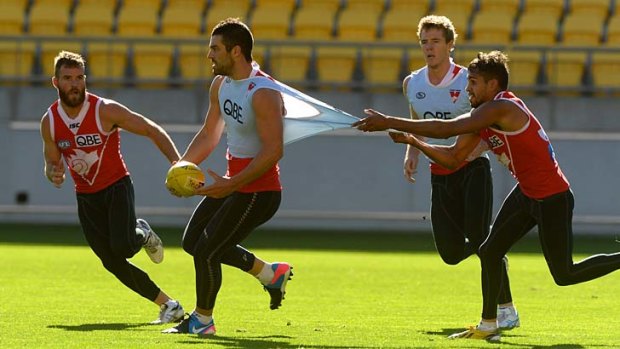 Quite a stretch: Lewis Jetta holds on to Heath Grundy's singlet in Wellington.