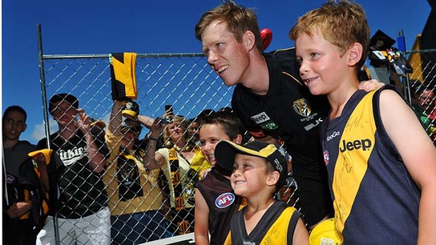 King of the kids: Jack Riewoldt poses for photos with fans at Richmond's family day.