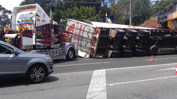 The truck rolled onto its side after slamming into the notorious rail bridge in South Melbourne.