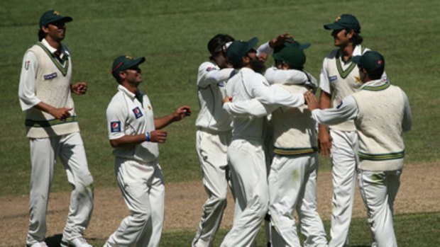 Pakistani teammates celebrate Shane Watson's run-out