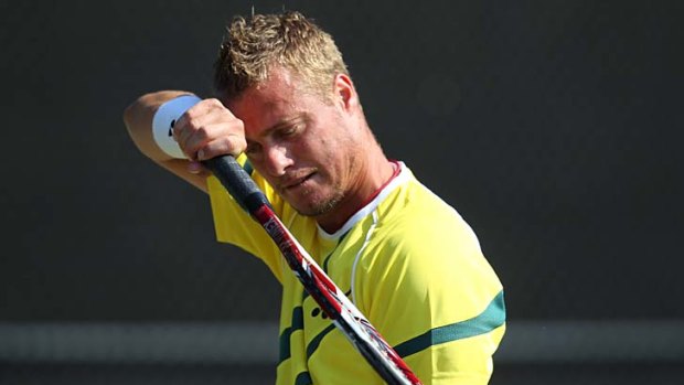 Feeling the strain: Lleyton Hewitt will carry Australia's hopes into a fourth day in the Davis Cup tie against Switzerland.